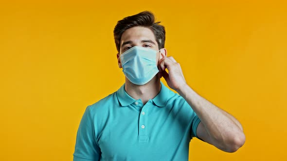 Pleased Man in Blue T-short Removed Protective Mask and Throws It on Floor As Symbol of Pandemic