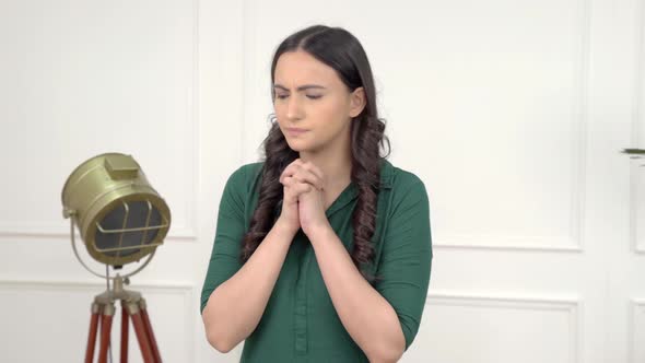 Afraid Indian girl praying