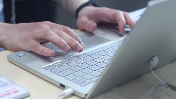 Businessman Is Typing On A Laptop In A Modern Office