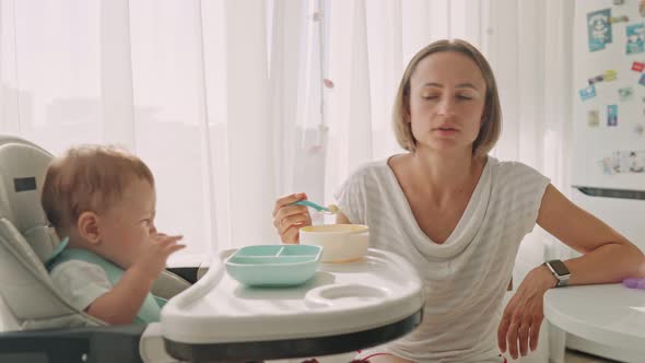 Baby Sits at a Children's Little Table