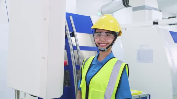 Asian woman worker people wearing protective safety helmet and glasses in production room in factory