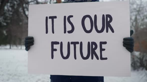 Big White Poster With a Sign IT IS OUR FUTURE, Single Person Protest