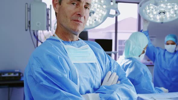 Close-up of mature Caucasian female doctor standing with arms crossed in hospital