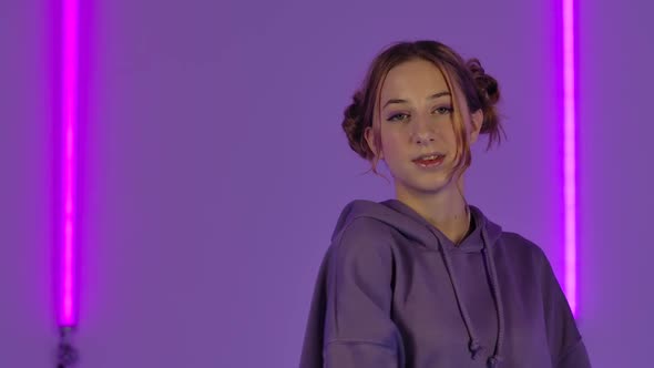 Portrait of Young Attractive Woman Poses at Camera