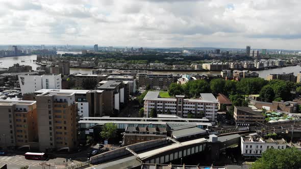 Establishing shot of Limehouse train station and Thames River in the background