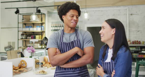 Animation of happy diverse female and male waiters at coffee shop