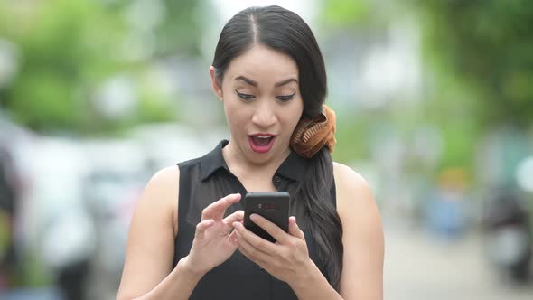 Young Beautiful Asian Businesswoman Using Phone in the Streets Outdoors