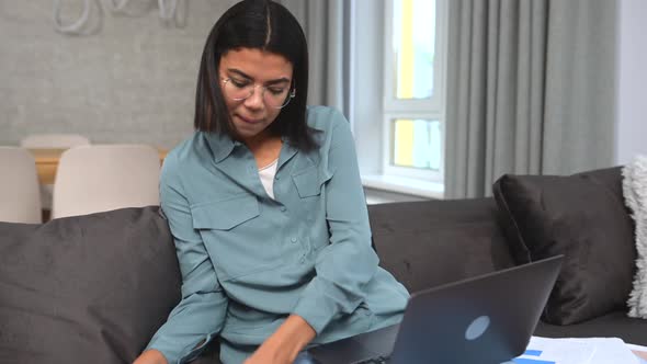 Multiracial Young Woman Spending Home Leisure with a Laptop