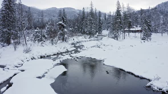 Ice and snow on stream banks at Kuźnice, Poland. Aerial forward