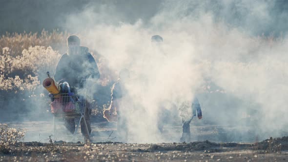 Survivor Family in Gas Mask Going Through Clouds of Toxic Smoke