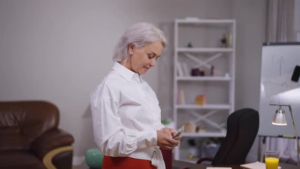 Happy Wealthy Rich Caucasian Elegant Businesswoman Counting Cash in Slow Motion Gesturing Victory