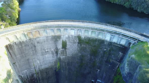 Aerial shot moving away from dam and blue water. New Zealand