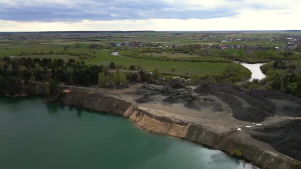 Aerial view basalt quarry of open pit mine machines with sifters conveyor belts
