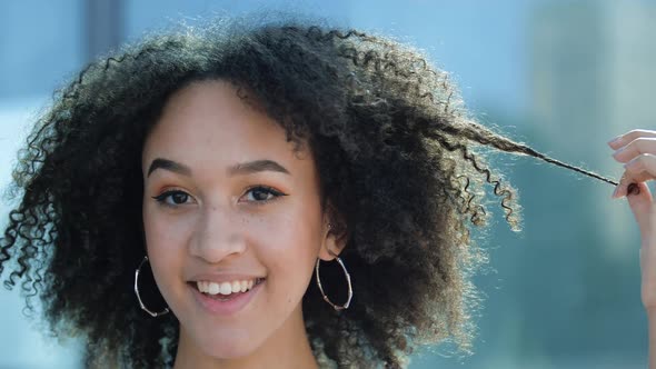 Close-up Face African American Ethnic Girl Curly Hairstyle. Young Beautiful Playful Woman Holding