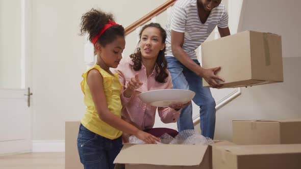 African American couple and their daughter moving into new house