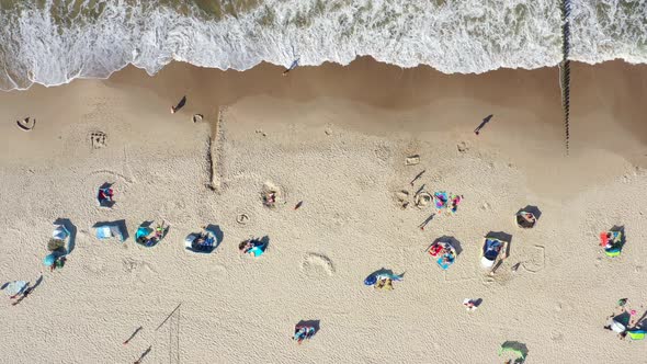 Baltic Sea coast beach Hel aerial drone top view 4K UHD video. People on the beach. Aerial View