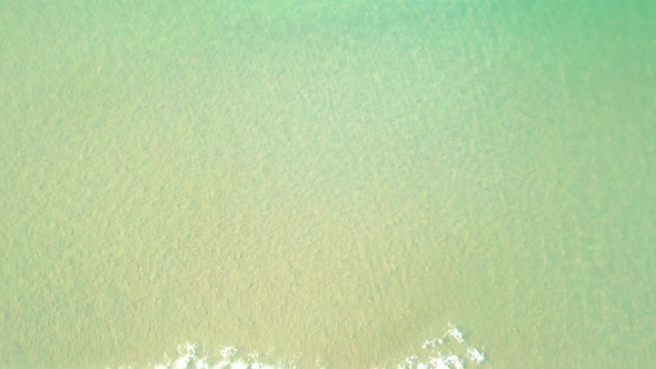 4K Aerial view top view of drone, sea waves and beautiful sand beach.