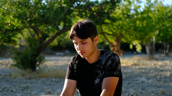 Young Man Worshiping Outdoors