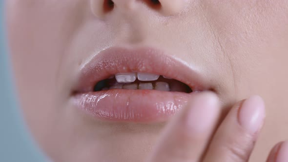 Close Up View of Young Woman Touching Her Lips 