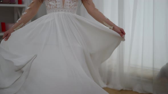 Happy Cheerful Middle Eastern Bride Spinning in Elegant White Wedding Dress Laughing