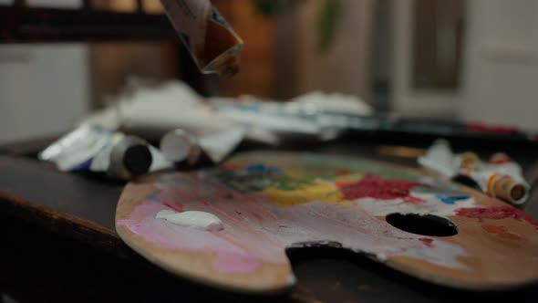 Close Up Shot of Unrecognizable Painter Squeezing Dye From Tube on Palette Preparing Supplies for