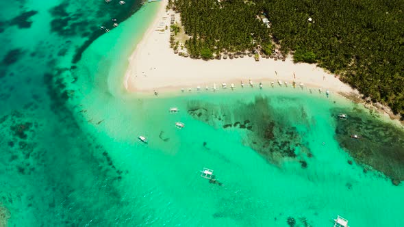 Tropical Daco Island with a Sandy Beach and Tourists