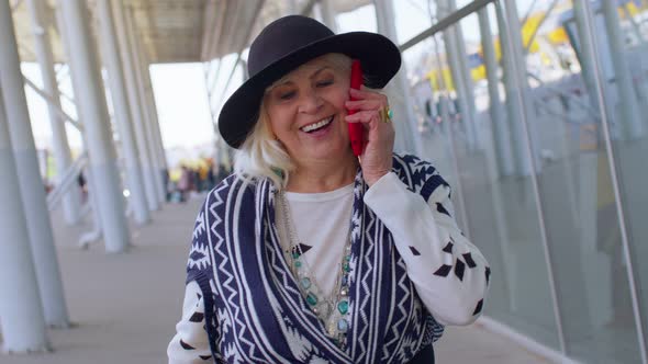 Senior Tourist Grandmother Woman Walking International Airport Hall Using Mobile Phone Conversation