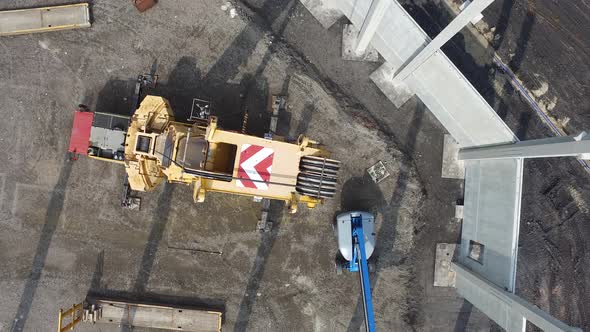 Aerial View of Huge Crane Installing Huge Reinforced Concrete Piles on Construction Site