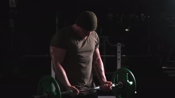 A Strong Guy Trains with a Heavy Bar