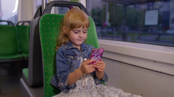 Girl Playing on Smartphone Chatting Texting Browsing Social Media While Traveling By Tram to City