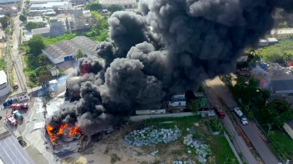 Flying Close Over a Massive Devastating Fire as it Consumes Large Commercial Warehouse Building Crea