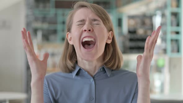 Portrait of Attractive Young Woman Screaming Shouting