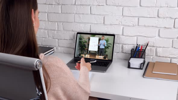 Businesswoman at Home Office Greets Listen Online Video Call Writes in Notebook