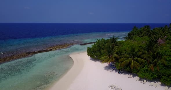 Natural flying travel shot of a summer white paradise sand beach and turquoise sea background