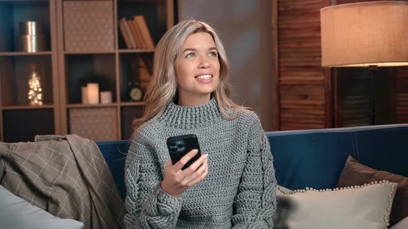 Happy Woman Chatting Use Smartphone Browsing Internet Relaxing at Evening Home with Positive Emotion