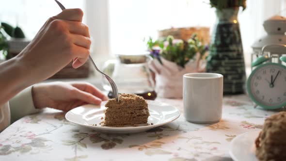 Woman Eats Piece of Homemade Honey Cake Using Stainless Fork