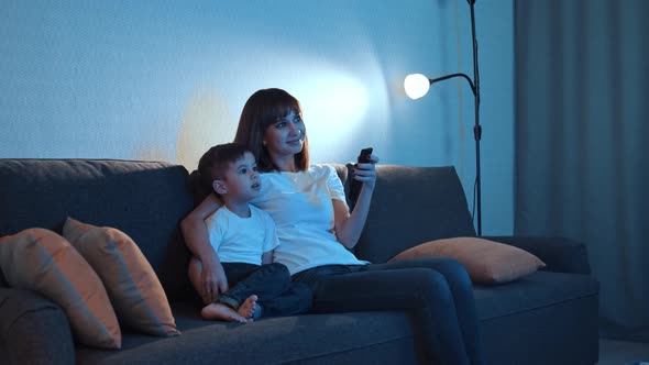 Happy Family  Mother Her Little Son Sits Couch Watching TV