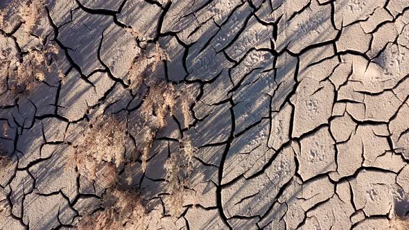 Flying over the cracked surface of a dry river