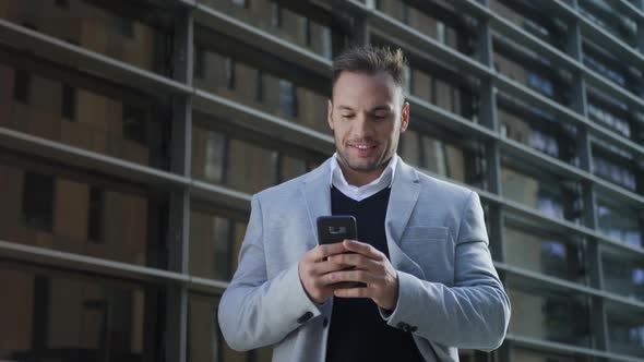 Business Man Receiving Good News on Phone. Worker Using Mobile Phone on Street