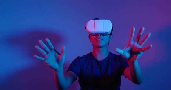 Man Looking Though the VR Device with Red and Blue Light