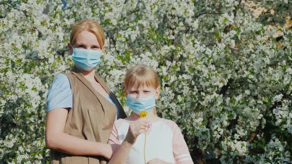 Two Men Who are Allergic to Masks Against the Background of a Flowering Tree