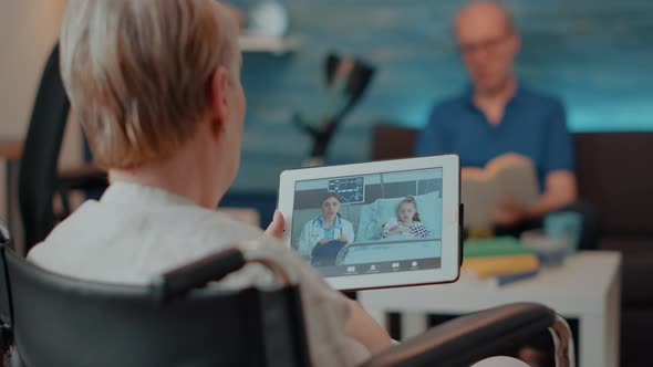 Elderly Person Holding Digital Tablet with Remote Videocall