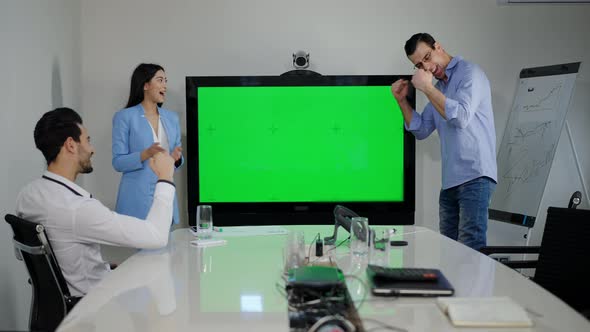 Wide Shot of Office with Chromakey Monitor and Group of Cheerful Multiracial Colleagues Making