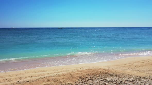 Aerial top down panorama of tropical island beach holiday by transparent sea with white sandy backgr