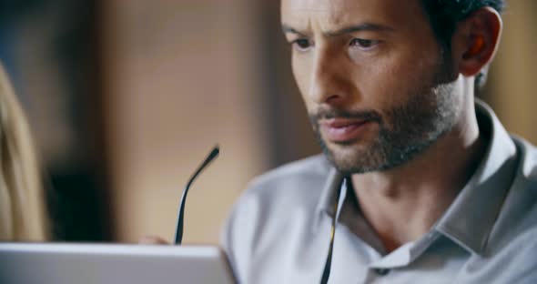 Man Wearing Eyeglasses Using Tablet