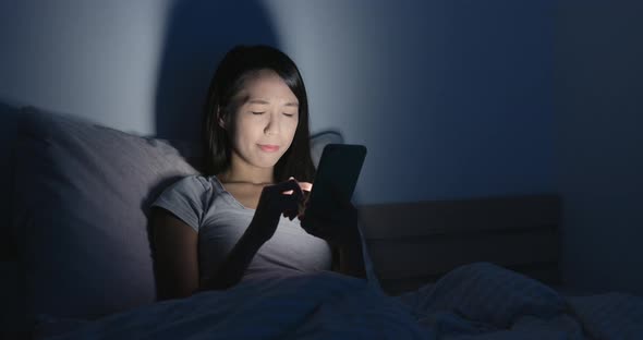 Woman using cellphone and pain of eye