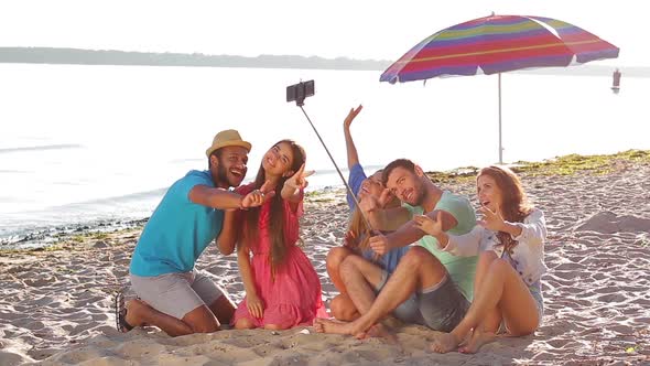 Cheerful Young People Doing Selfie on the Beach.