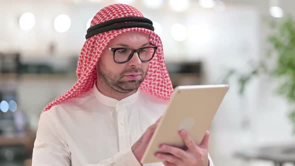 Attractive Young Arab Businessman Using Digital Tablet