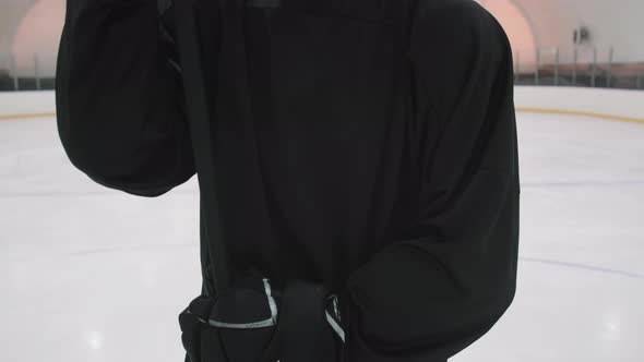 Portrait Of Male Hockey Player In Black Uniform