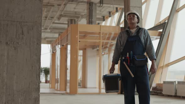 Female Builder in Building under Construction